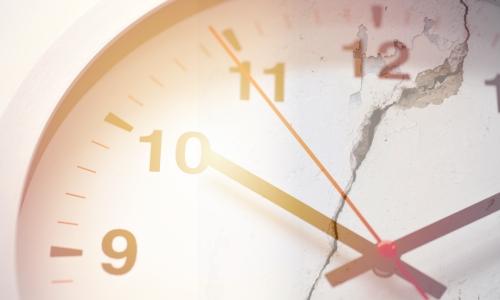 Photo illustration of a clock and cracked concrete defective construction