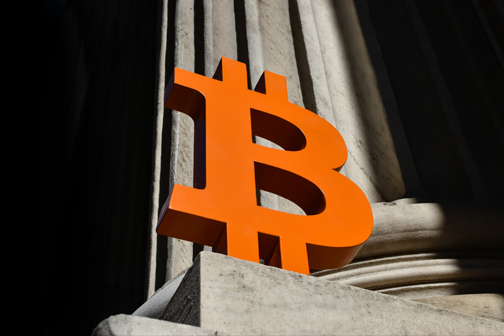 Cryptocurrency symbol in front a judicial column