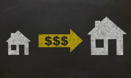 Illustration of two houses of different sizes connected by an arrow with dollar signs, representing mortgage repurchase demands.