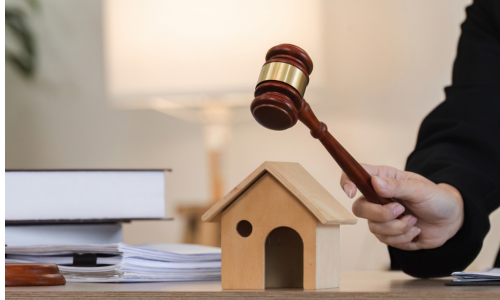 Real Estate Law Concept with Judge's Gavel and Model House on Desk stock photo