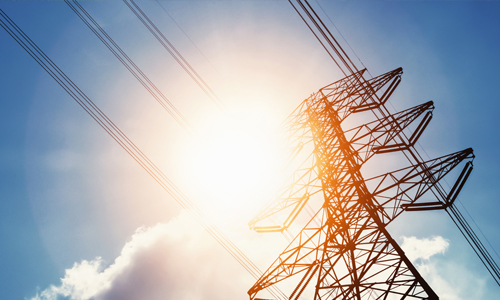 Image of an electric line tower in the sun