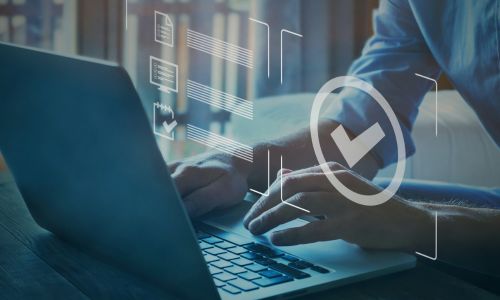 Conceptual Image of a person in front of laptop checking off things on a list.