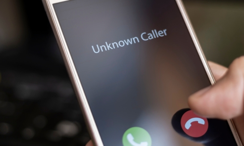 Photo of cell phone screen showing unknown caller illustrating Florida Legislature Rolls Back Mini-TCPA While Florida Courts Make TCPA Claims 