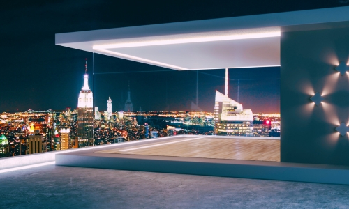 Luxury New York City pied-à-terre with a rooftop terrace overlooking the Manhattan skyline at night, representing high-value residential properties potentially subject to New York’s Pied-à-Terre Tax.