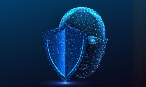 Digital face made of blue network lines behind a glowing shield, representing facial recognition and cybersecurity.